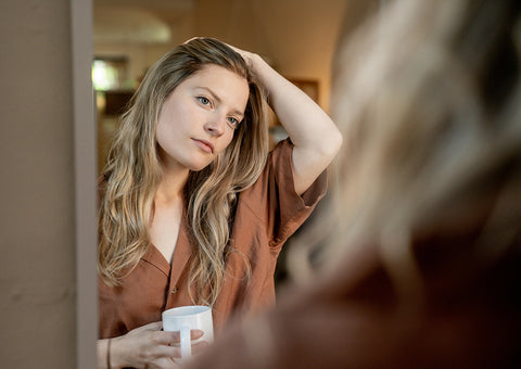 woman looking in mirror